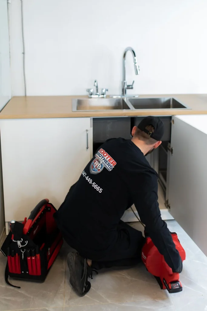 Plumbing repair under a sink in an Oakville home