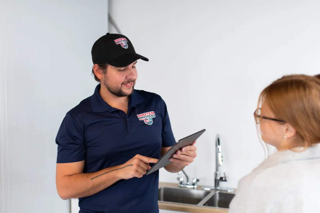 Licensed plumber in Richmond Hill explaining a repair to a homeowner